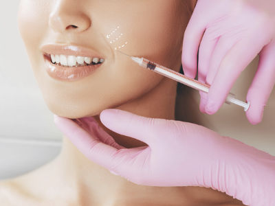 dermal fillers injection in woman's face